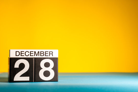 December 28th. Image 28 day of december month, calendar on yellow background with empty space for text