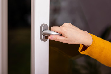 Woman opens the window to ventilate