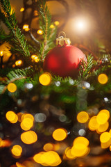 Fototapeta na wymiar Red glass Christmas ball and lights