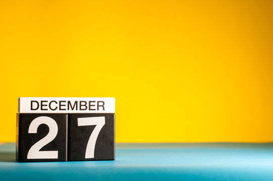 December 27th. Image 27 day of december month, calendar on yellow background with empty space for text