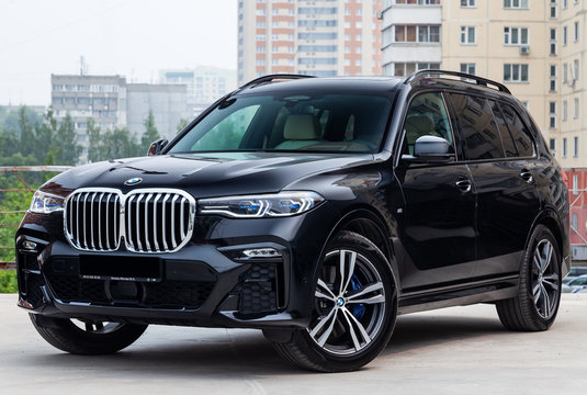 Black new BMW X7 xDrive40i 2019 year front view with light gray interior on parking in the street