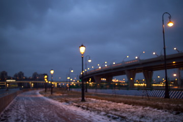 promenade with lanterns on a dark winter evening