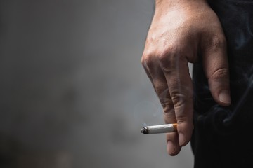 hand with a cigarette © Chaipong