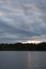 Stormy clouds and sunset over the water