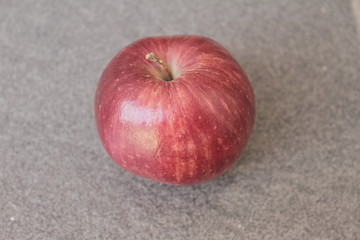 red apple on wooden table