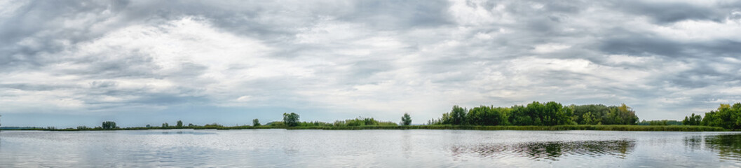 Panorama of the lake with a forest on the opposite shore