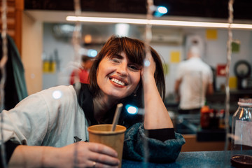 Happy woman in the street cafe