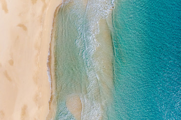 Amazing Beach and waves from top view. Turquoise water background. Summer seascape from air. Summer Background. Top view from drone. Travel concept and idea. North Cyprus, Golden Beach.