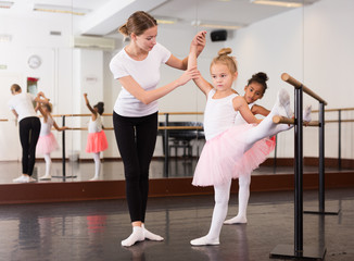 Ballet trainer teaching two little girls