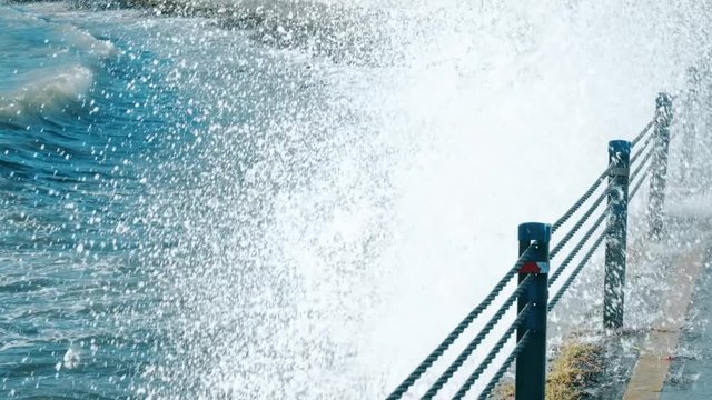 Slow motion huge waves crashing over seawall at daytime in Istanbul