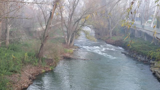 View of the river Ges from the bridge that crosses it in Les Berdisas a foggy day, Torello, Osona, Catalunya, Spain