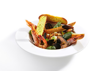 Assorted Seafood with Garlic Baguette on Restaurant Plate Isolated