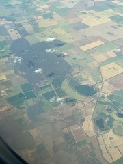 Dark fields in the rough shape of a person as seen from a plane