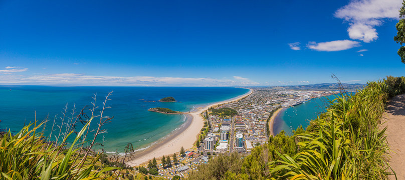 Panoramic picture of Tauranga city with Papamoa Beach from Mount Mainganui on northern island of New Zealand in summer