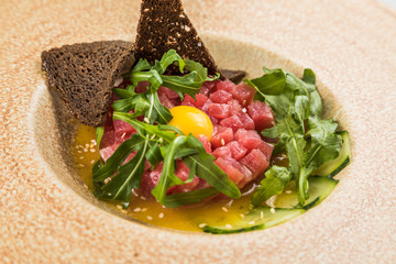 Delicious tartare of tuna and mango with a micro green salad