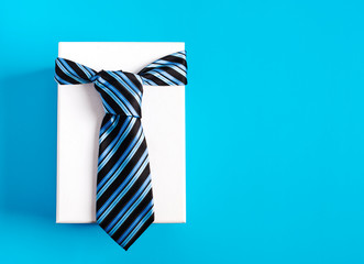 Gift box with blue striped tie. Happy father's day idea, sign, symbol. Holiday background
