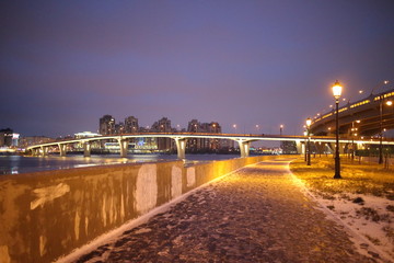 promenade with lanterns on a dark winter evening