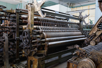 An old machine at an abandoned textile factory