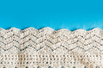 Fototapeta na wymiar Knitted shawl background. Shawl from goat yarn, made by hand knitting