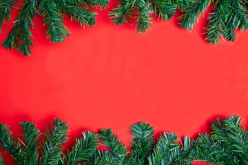 Christmas composition with decorated christmas tree on red background with copy space