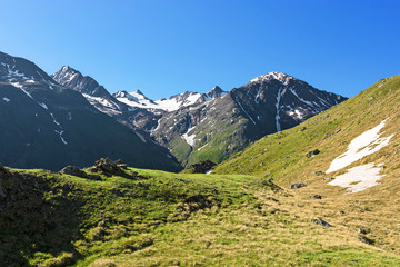 Fototapeta na wymiar Alpine landscape in summer. Mountains, snow and green pastures. Ötztal Alps, Tirol, Austria
