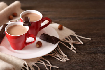 Red cups of flavored cocoa on a plaid