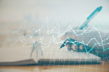 Forex graph on hand taking notes background. Concept of research. Multi exposure