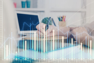 Financial graph displayed on woman's hand taking notes background. Concept of research. Double exposure