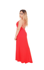 Fototapeta premium Beautiful blond woman standing in red dress in profile