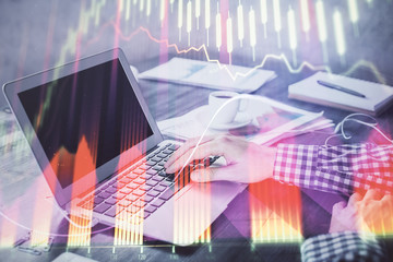 Double exposure of forex chart with man working on computer on background. Concept of market analysis.