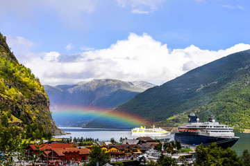 cruise ship under a rainbow in the fjords of norway