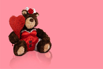 teddy bear with a heart on a pink background,. valentine's day concept