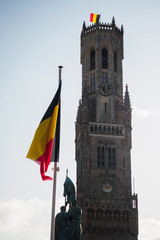 Belfry of Bruges with the Belgian flag from the market square - Bruges, Belgium