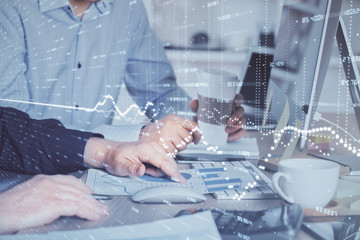 Multi exposure of chart with man typing on computer in office on background. Concept of hard work.