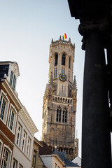 Fototapeta na wymiar View of the tower of the Bruges market square from the typical streets of the Belgian city - Bruges, Belgium