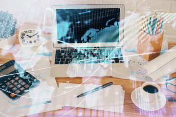 Financial chart drawing and table with computer on background. Double exposure. Concept of...