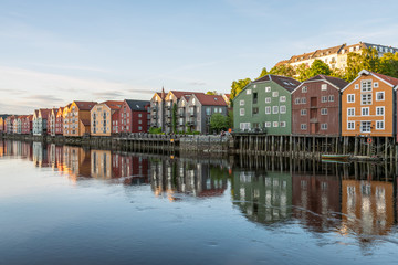 Fototapeta na wymiar Colorful wooden buildings near Nidelva river in the city of Bakklandet/Trondheim in Norway. Architecture, buildings, travel and photography concept.