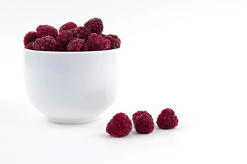 Frozen raspberries on a white background. Top view. Copy space.