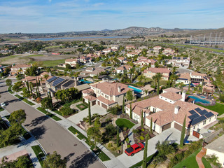 Fototapeta na wymiar Aerial view of neighborhood with residential modern subdivision luxury houses and small road during sunny day in Chula Vista, California, USA.
