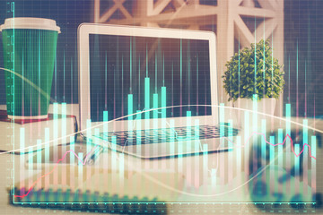 Stock market graph and table with computer background. Multi exposure. Concept of financial analysis.