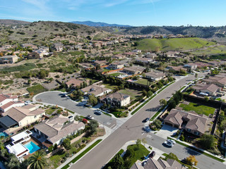 Fototapeta na wymiar Aerial view of neighborhood with residential modern subdivision luxury houses and small road during sunny day in Chula Vista, California, USA.