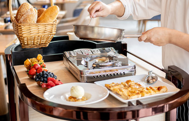 Chef's hands  stirring mixed berries jam for compote and bread pudding