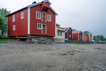 Old wooden building on the beach in the city of Mosjoen in Northern Norway during rainy weather. Architecture, landscape near me and travelocity concept.