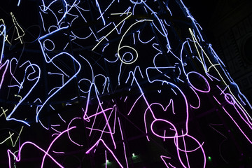 Illuminated Christmas tree in Piazza Santa Maria Novella with the Basilica on the background. Italy.