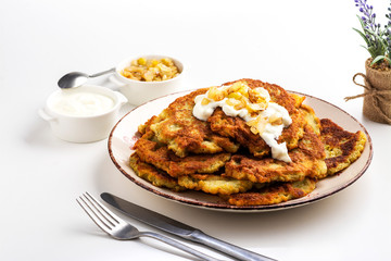 Exposition of home made potato pancakes on white table, traditional tasty food.
