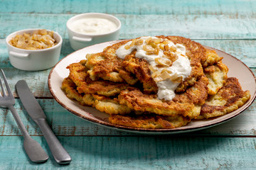 Exposition of home made potato pancakes on wooden table, traditional tasty food.
