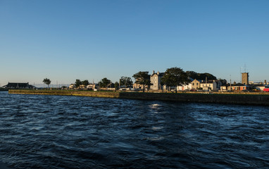 View of the river Corrib flowing through Galway city. Taken on a sunny summer morning at sunrise.
