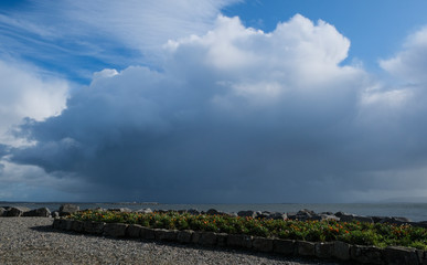 Rain cloud and rain fall over the water of Galway bay, taken on a summer day from Salthill...
