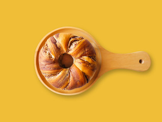 Isolated homemade food bakery, Closeup delicious donut japanese bun style served on wooden dish  with yellow background
