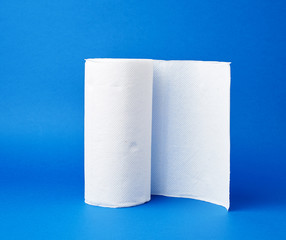 twisted roll of white paper towel on a blue background